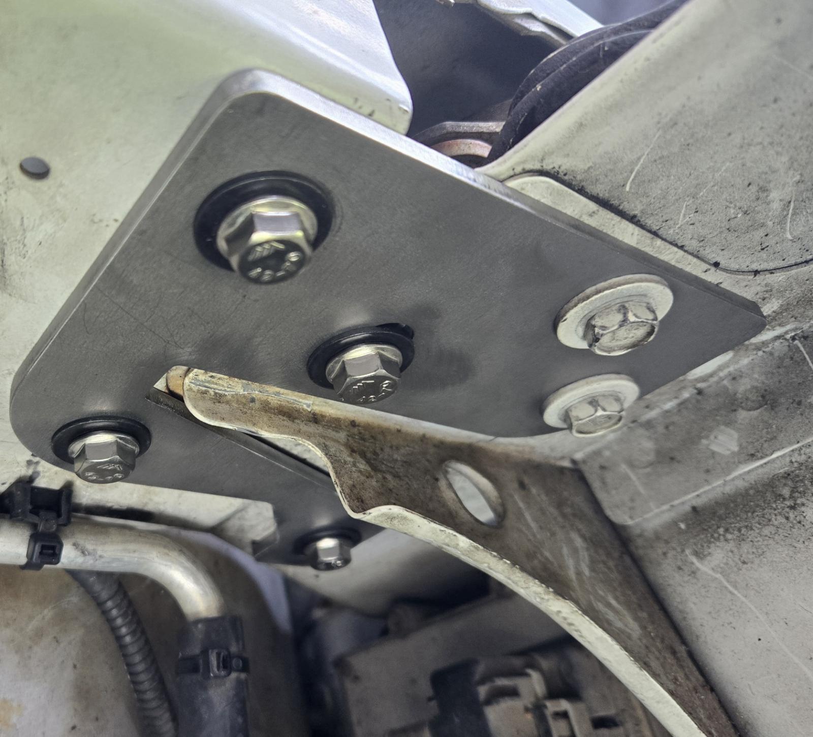 Cracked bodywork at hood hinge